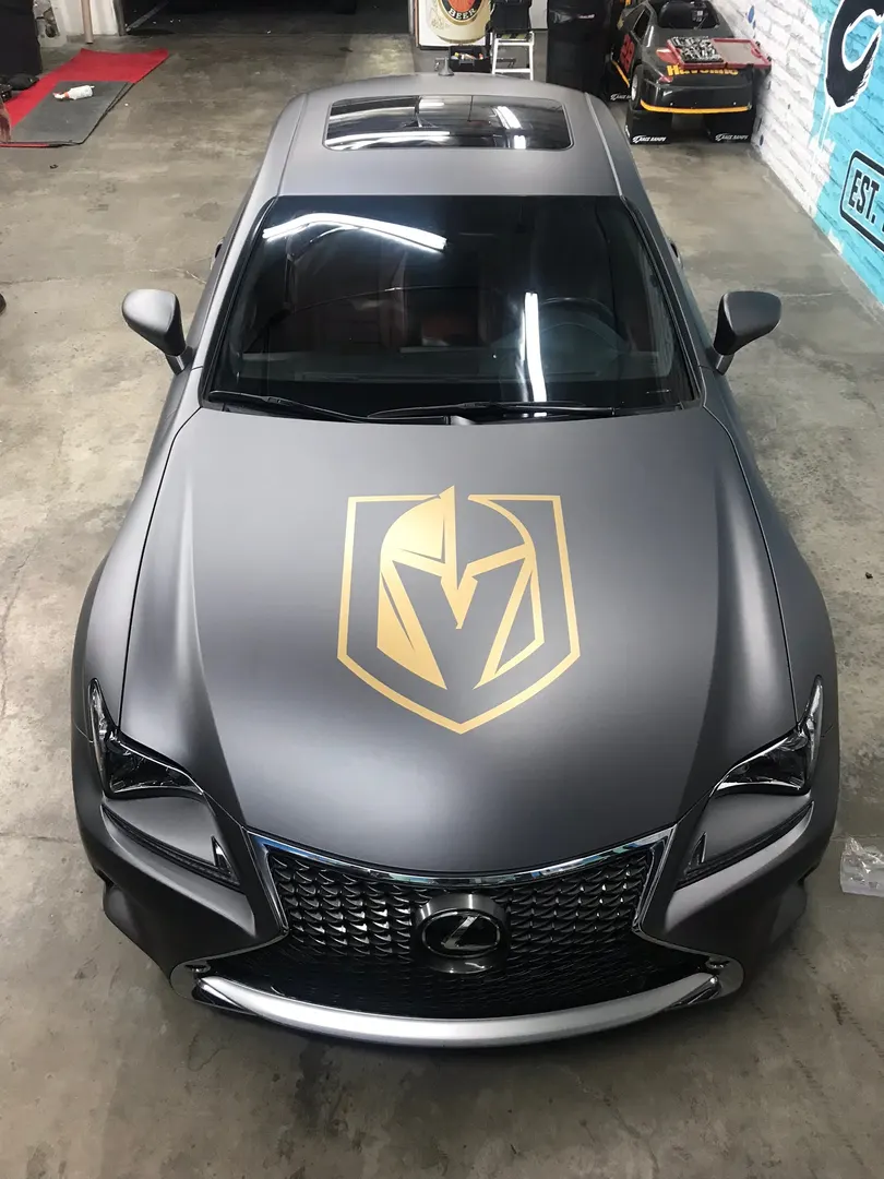 Front three-quarter on the same car — the hood graphic reads clean against matte.