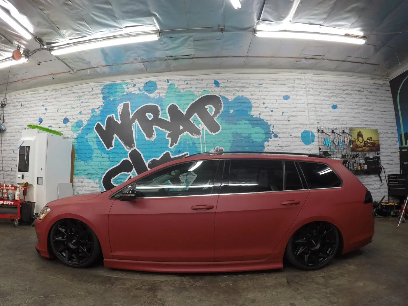Wagon in satin red — the finish that sits between matte and gloss, photographed under shop lighting.