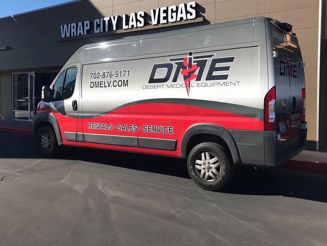 High-roof cargo van in a two-tone print wrap, phone number and web address set large along the flank.