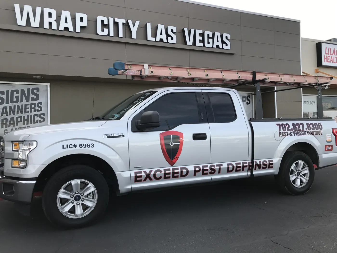 Pickup in fleet livery outside the shop