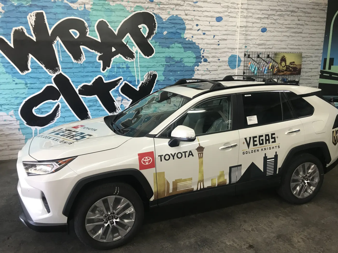 SUV in a team wrap with a printed Vegas skyline running the length of the doors.